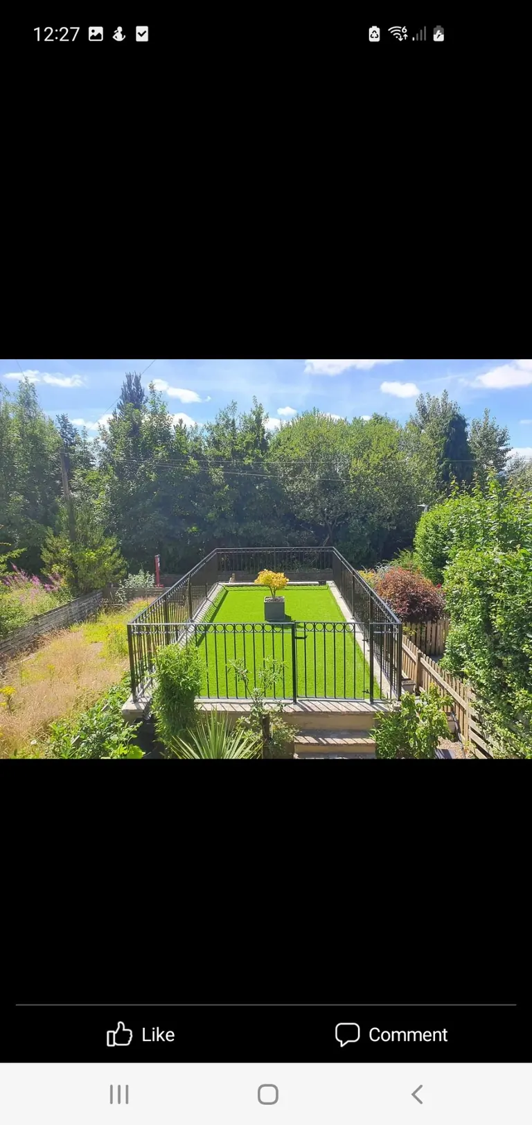 Artificial grass installed on a raised balcony terrace with railings