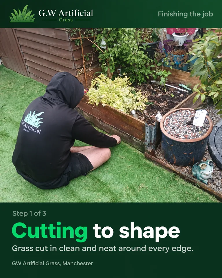 Cutting the artificial grass to fit the garden perimeter.